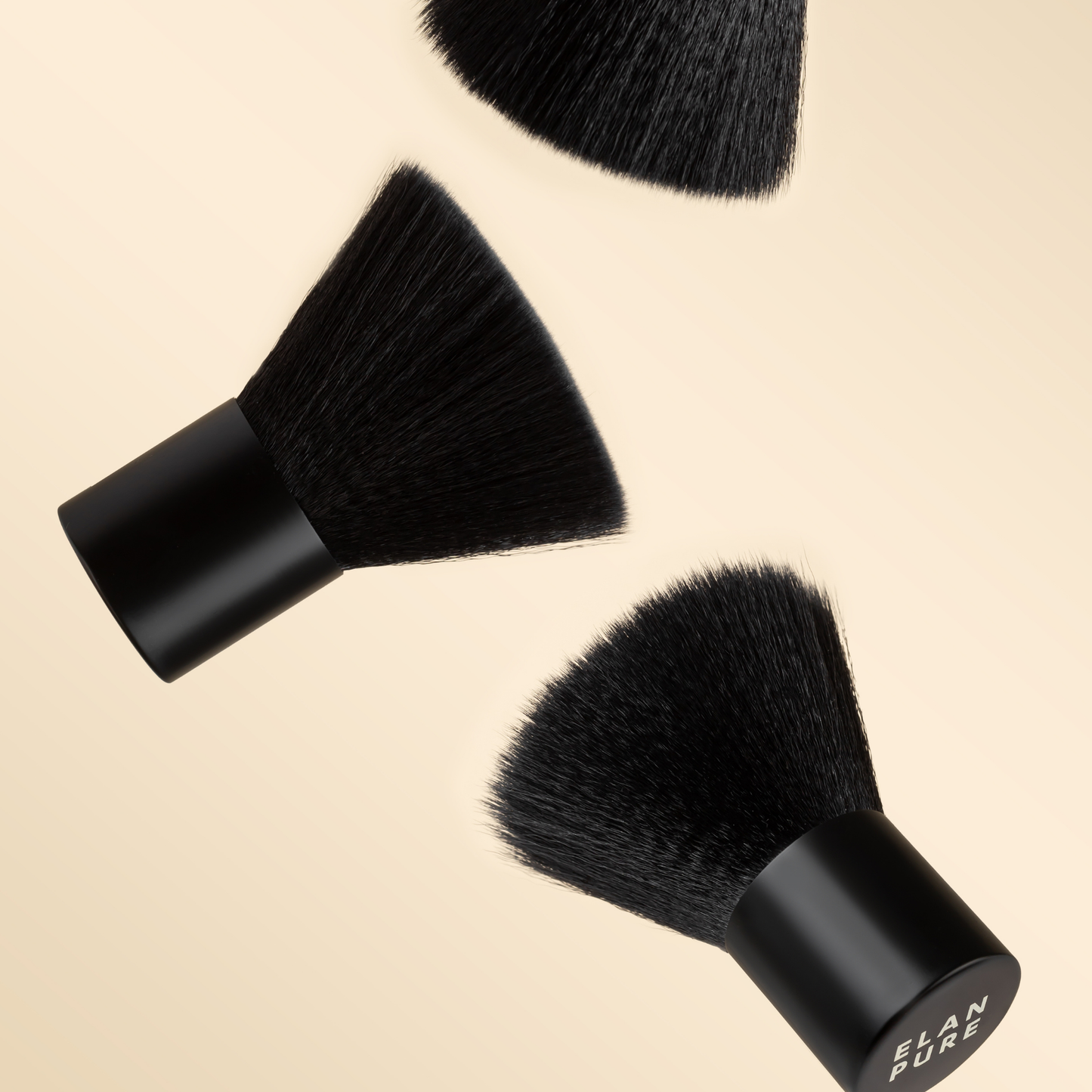 Three black makeup brushes with 'Elan Pure' branding on a beige background